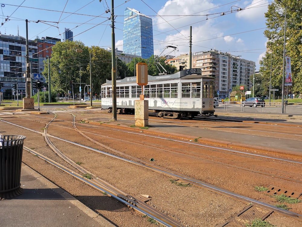 white and brown train on rail tracks during daytime