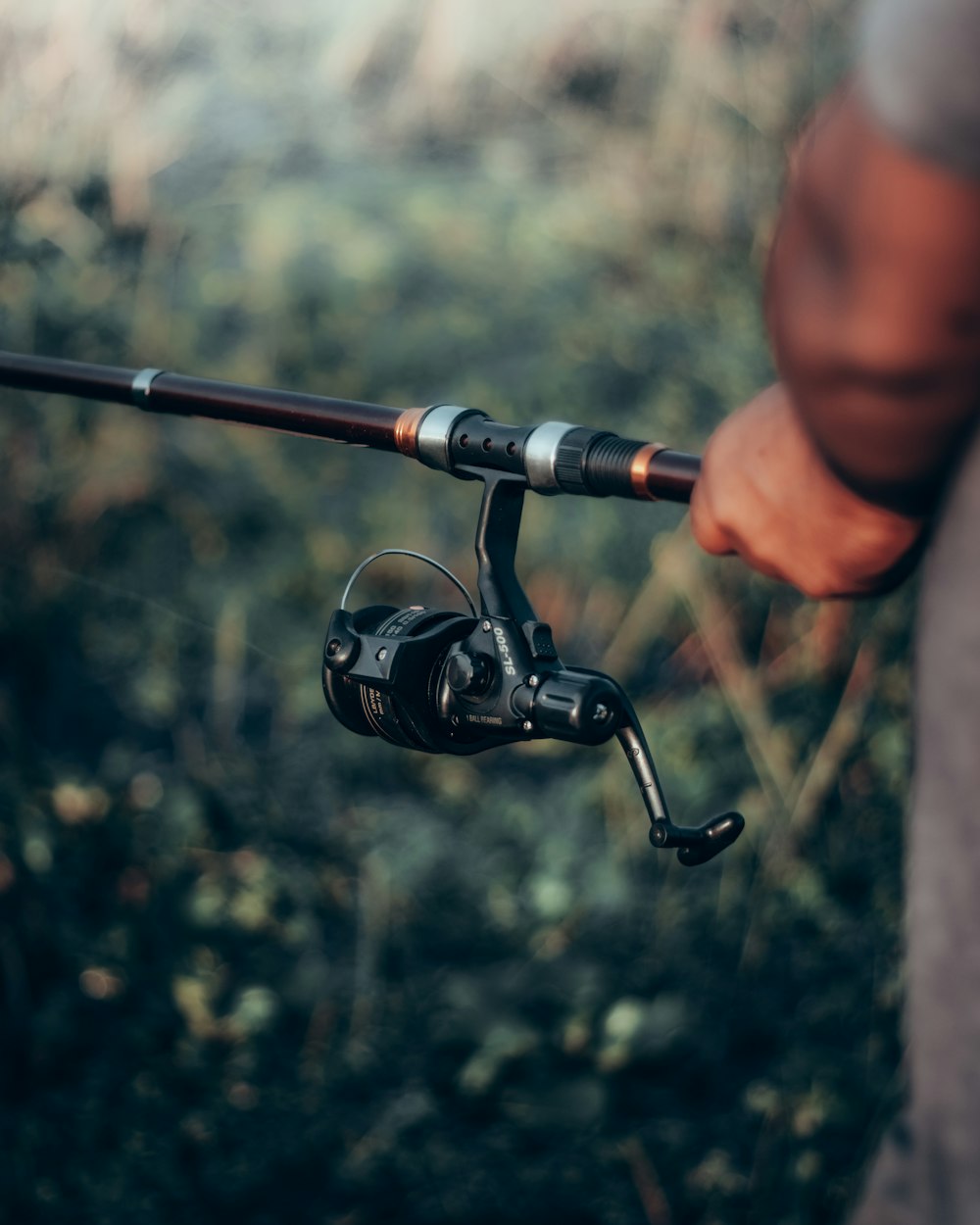 black and silver fishing rod