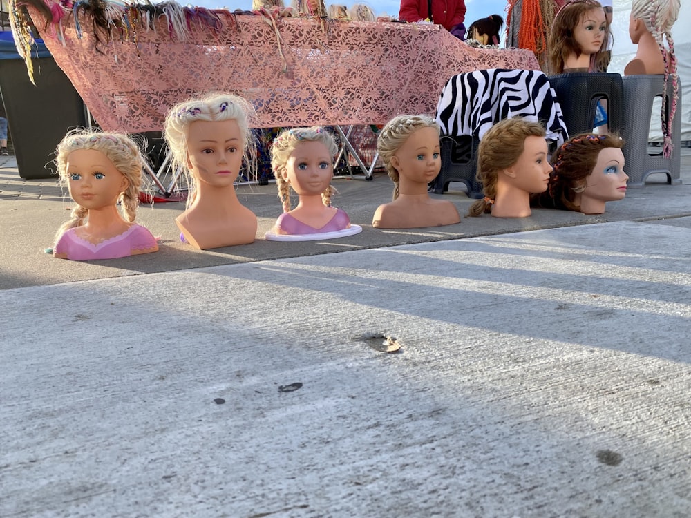 children sitting on gray concrete floor during daytime