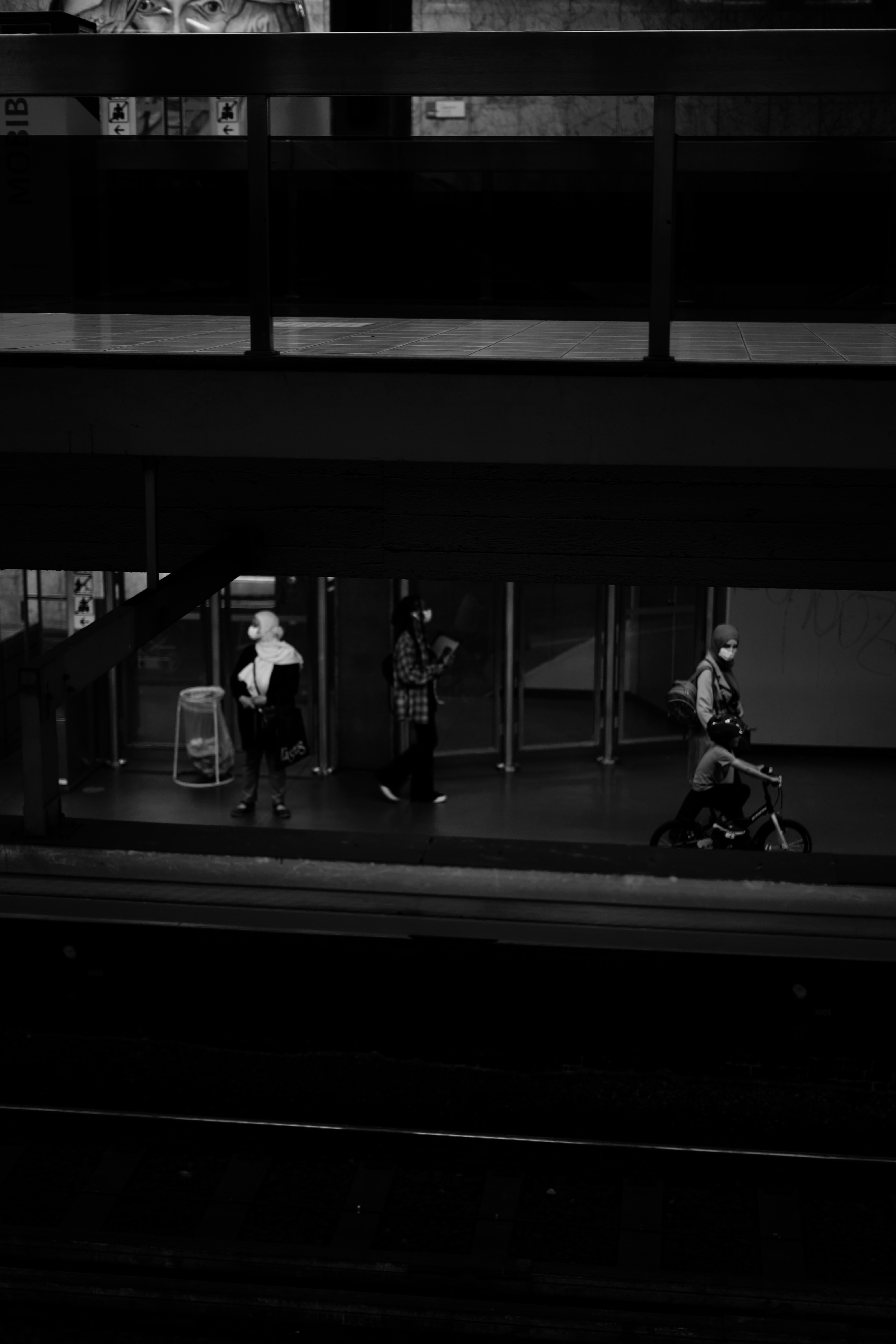 grayscale photo of 2 men walking on train station