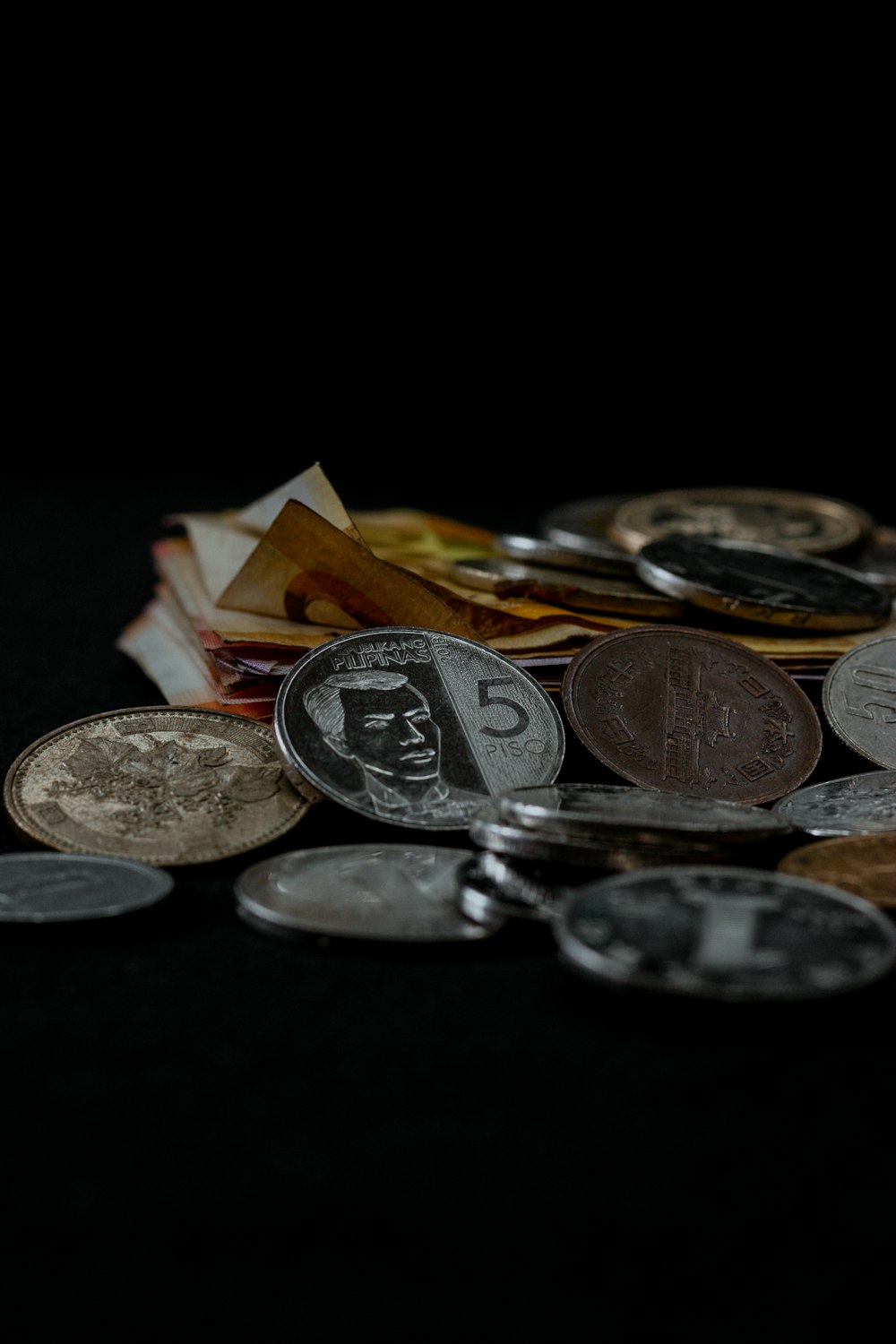 silver and gold coins on black surface