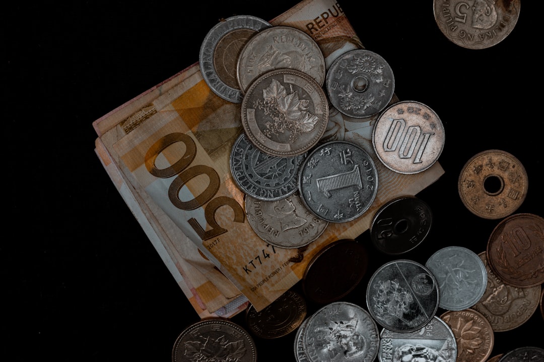 silver and gold coins on banknotes