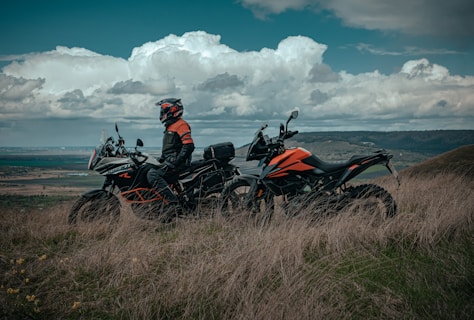 man riding on red and black sports bike