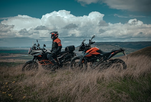 man riding on red and black sports bike