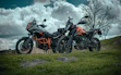 black and red sports bike on green grass field under blue sky during daytime