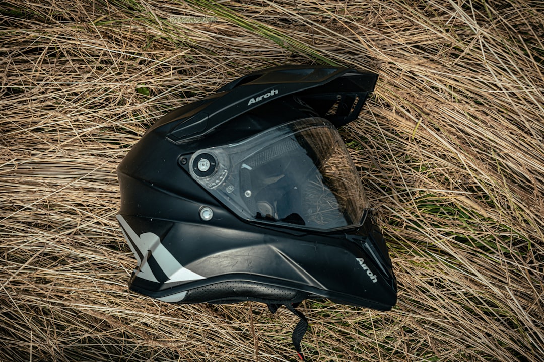 black and white helmet on brown grass