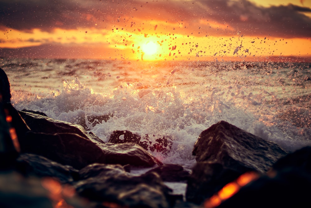 rocky shore during sunset with sea waves