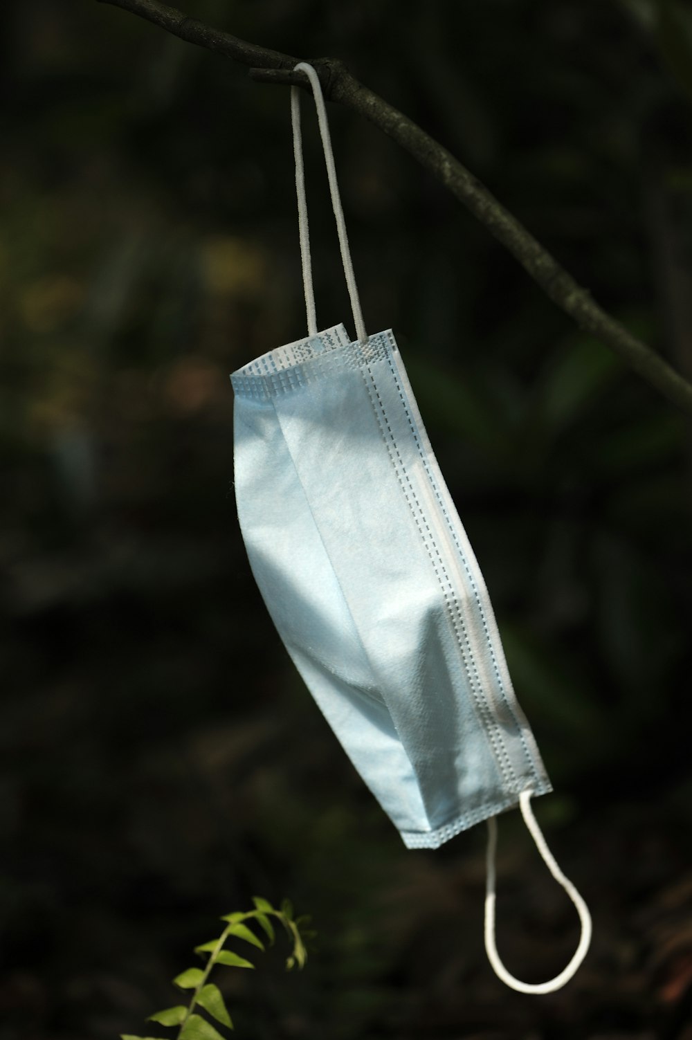 white textile hanging on black wire