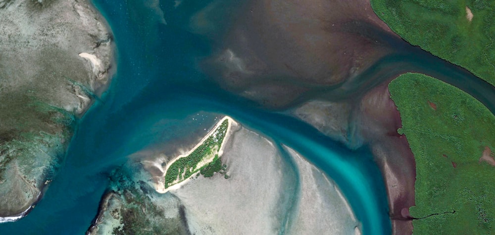 aerial view of green island in the middle of the sea