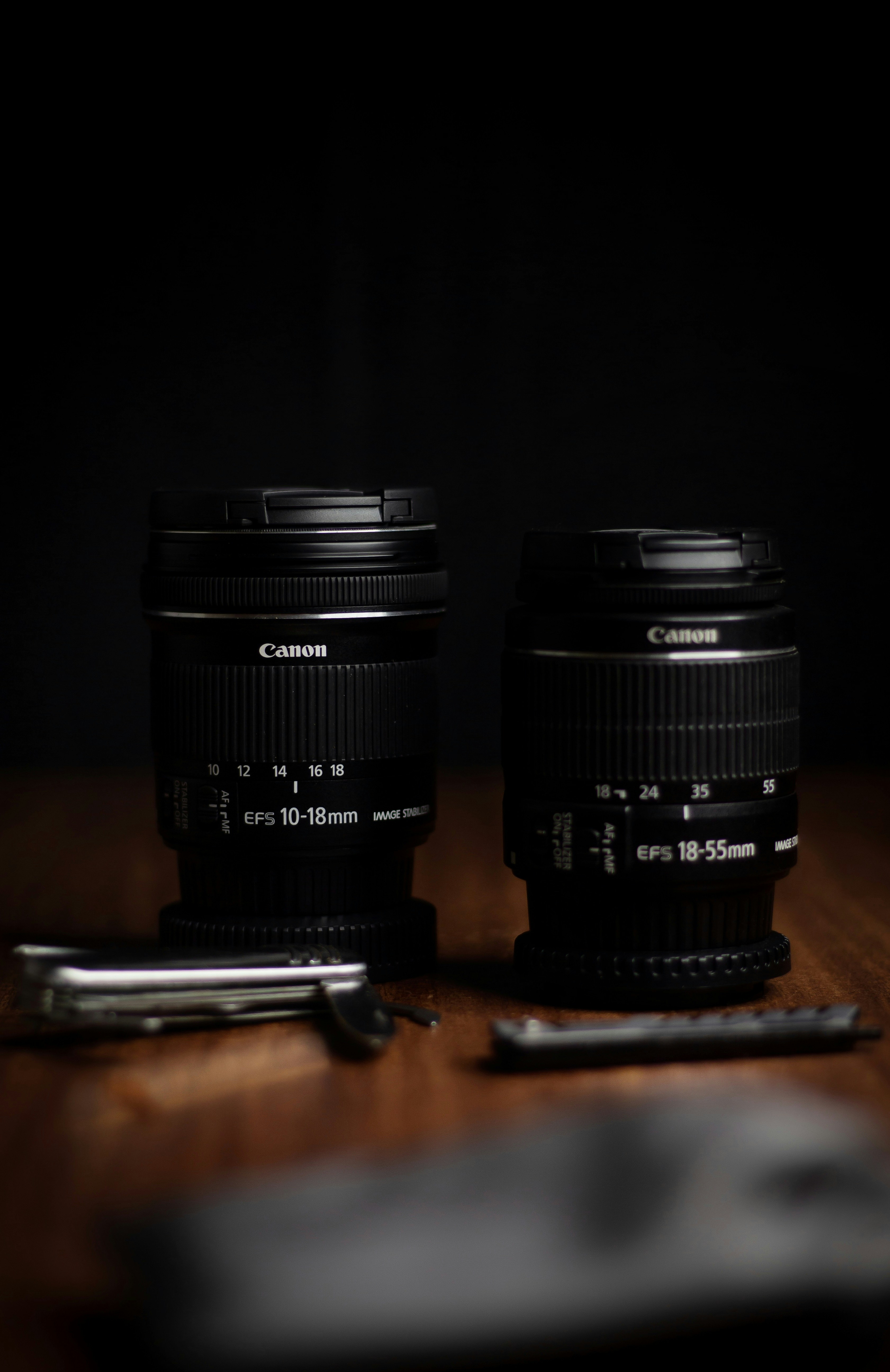 black camera lens on brown wooden table