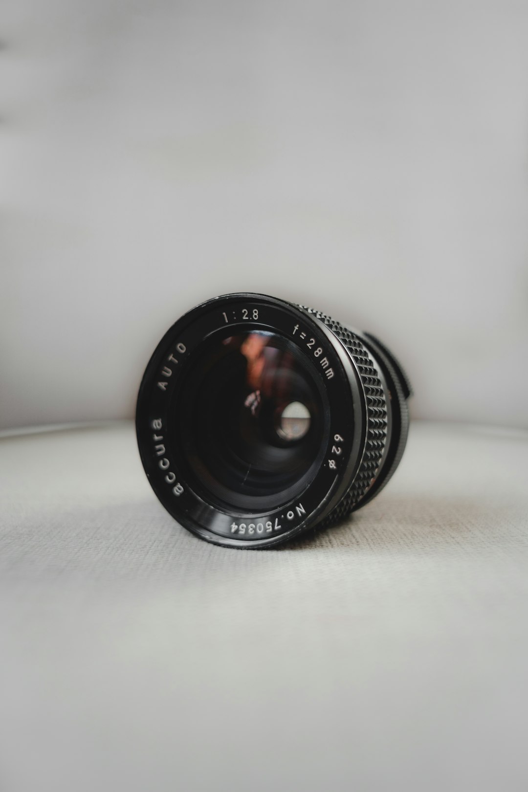 black camera lens on white table