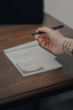 person writing on white paper