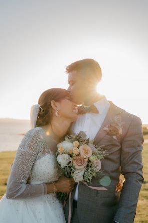 man and woman kissing during daytime