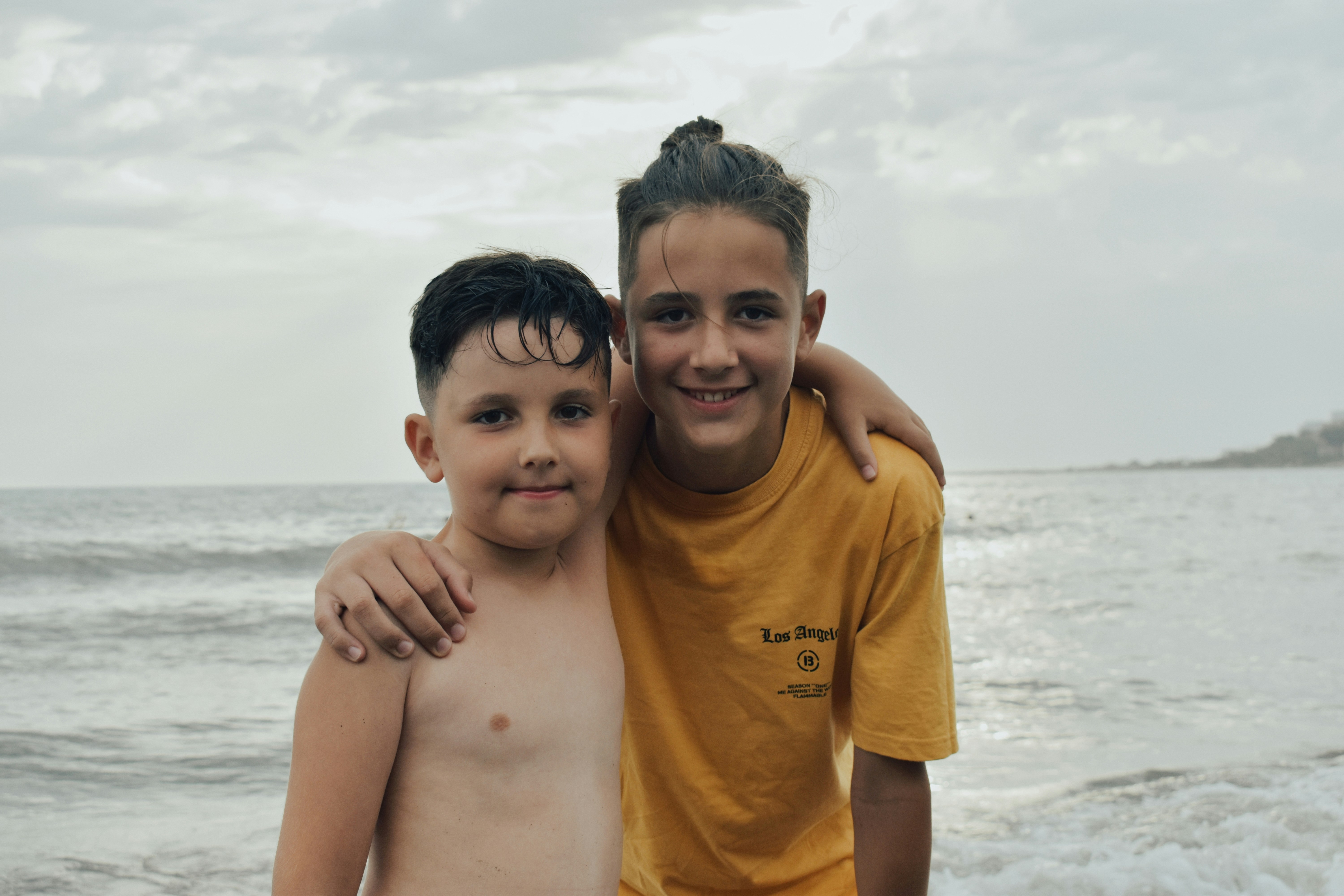 boy in yellow crew neck t-shirt smiling