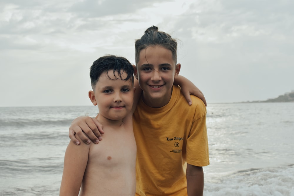 boy in yellow crew neck t-shirt smiling