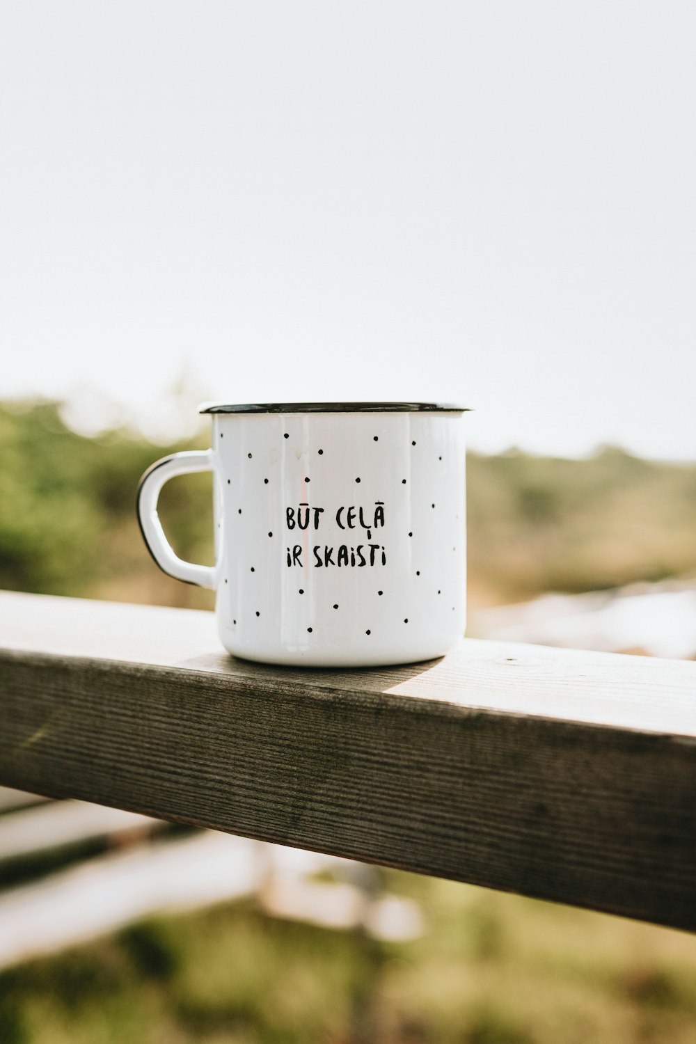 white ceramic mug on brown wooden table