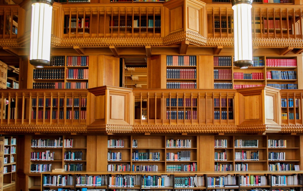 brown wooden book shelves in library