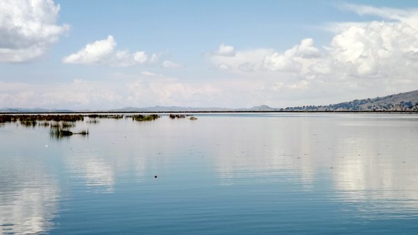 Body of water under blue sky during daytime — Lake Titicaca, Peru
