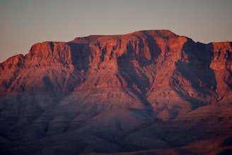 A stunning landscape photograph showcasing a mountain range at sunset.