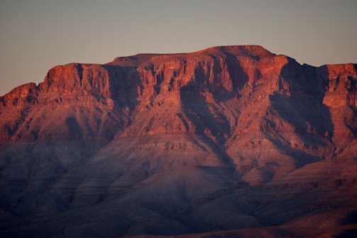 A stunning landscape photograph showcasing a mountain range at sunset.