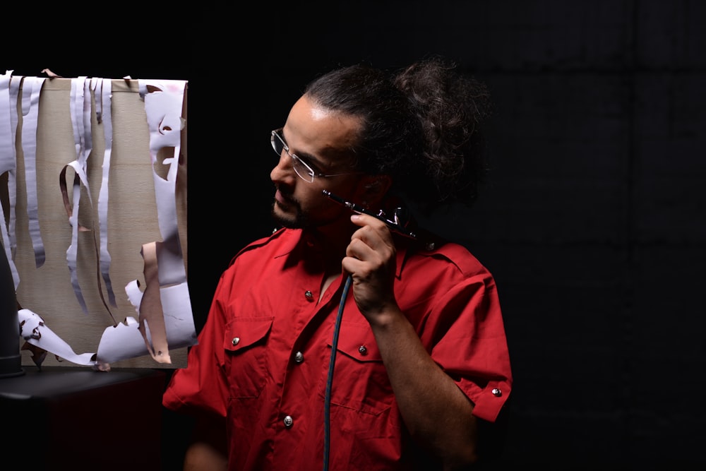 woman in red button up shirt wearing black framed eyeglasses