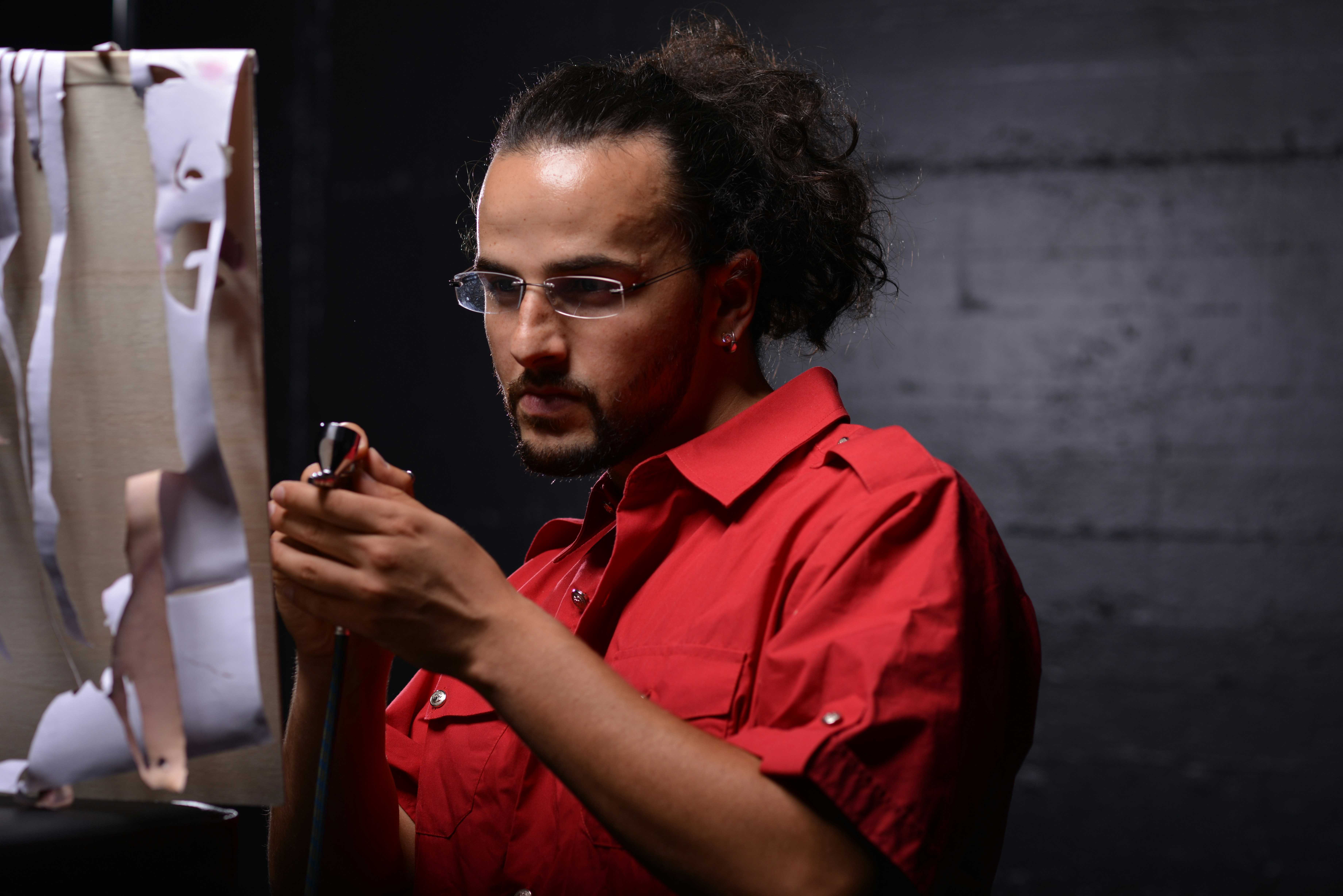 Airbrush Artist is focus on his bord 

Photo done by  Norbert Munich https://www.facebook.com/norbert.fotoevents