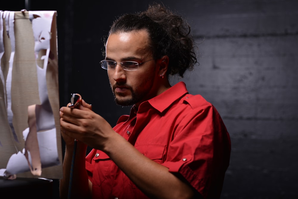 man in orange button up shirt wearing black framed eyeglasses