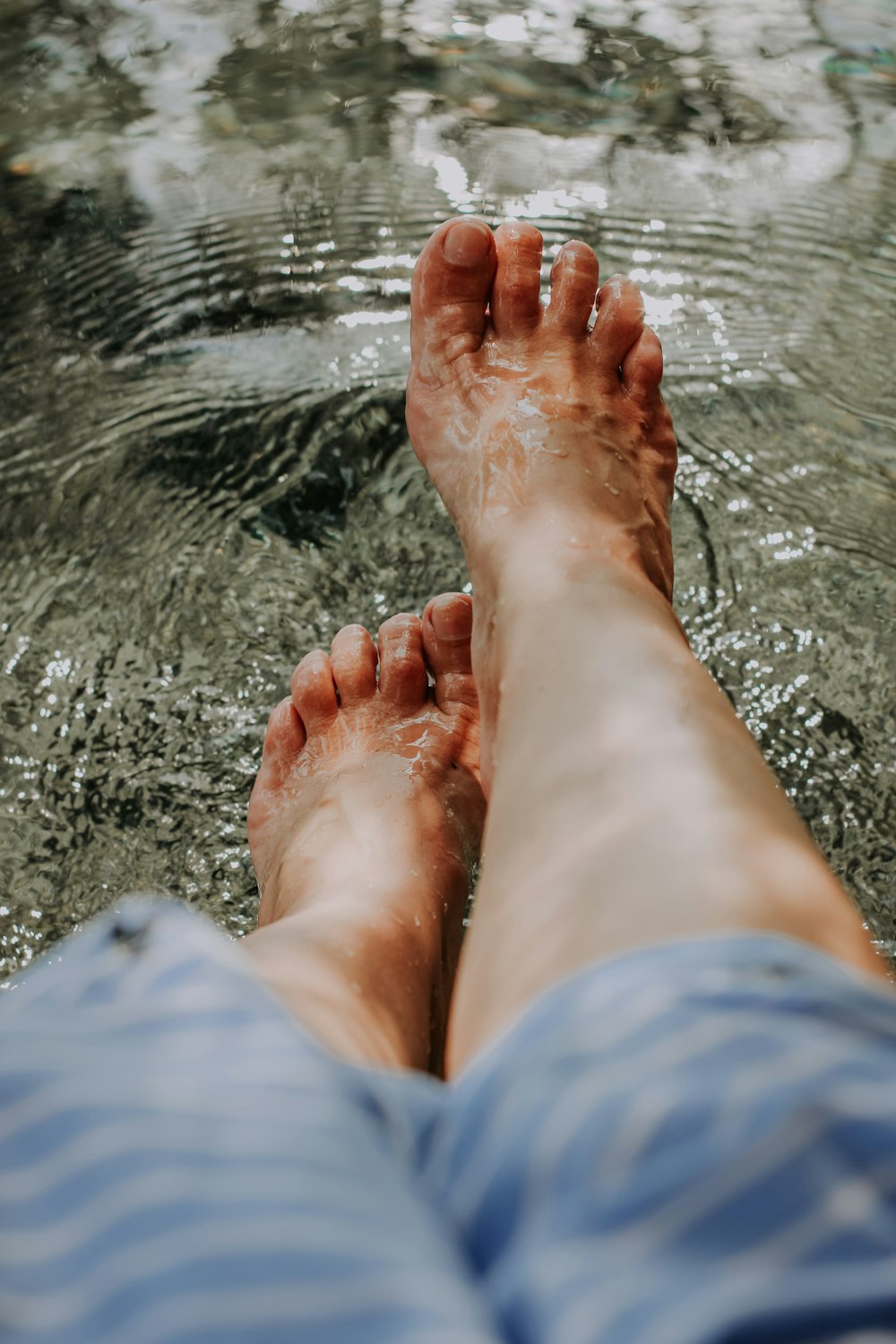 person in blue denim shorts on water