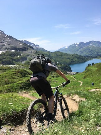 A mountain biker riding down a rugged trail with panoramic views