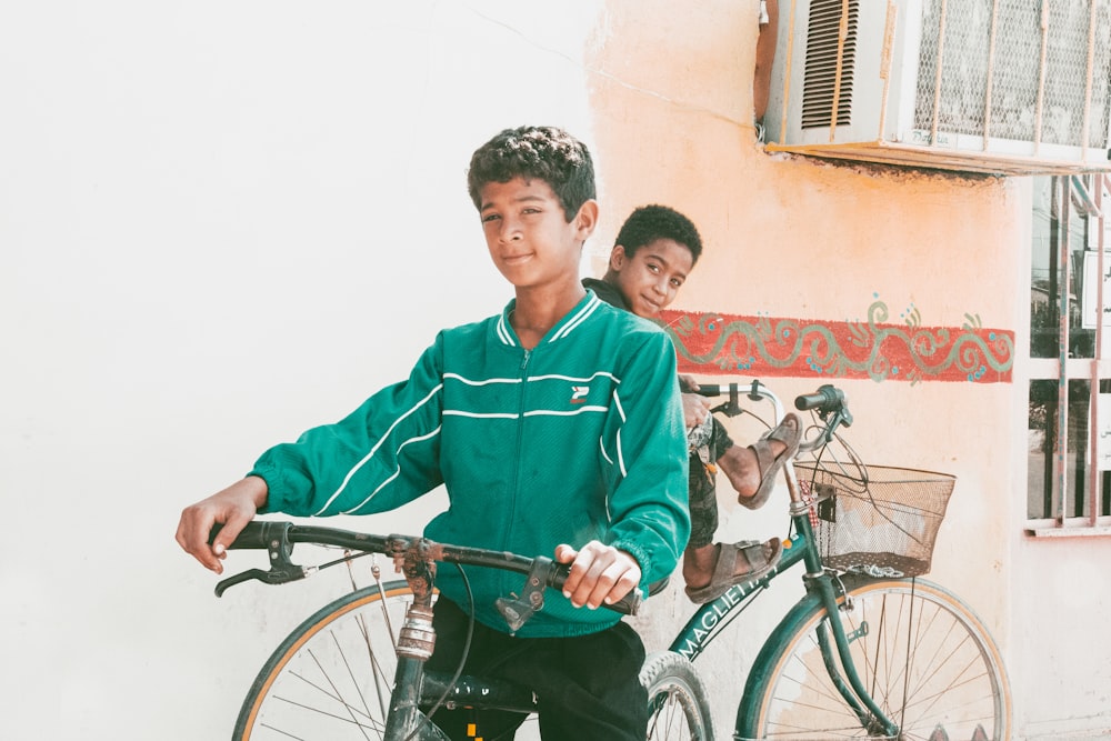 man in green zip up jacket riding on bicycle