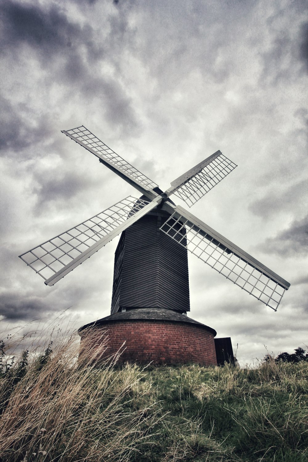 brown and gray windmill under cloudy sky during daytime
