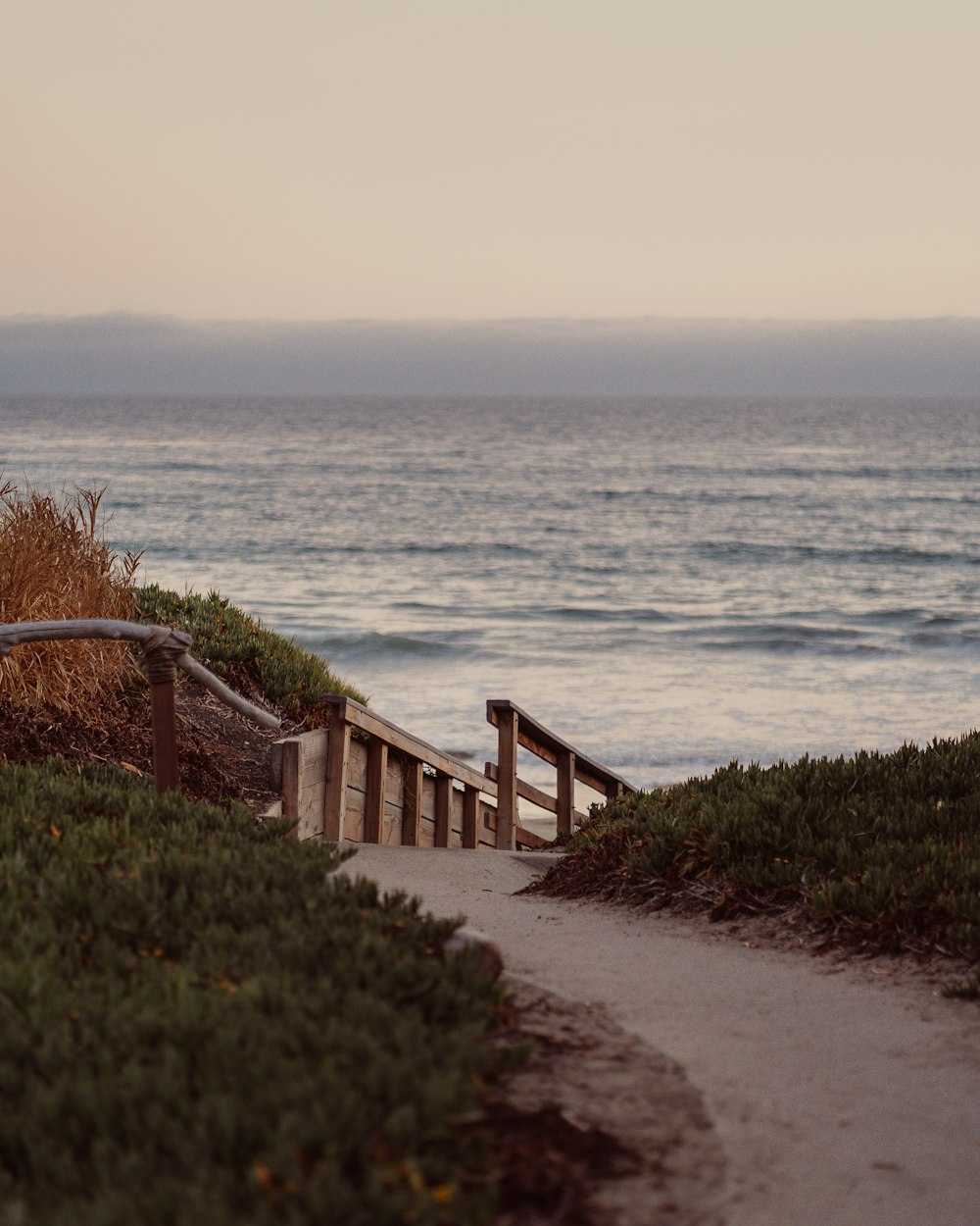 brown wooden staircase on beach during daytime