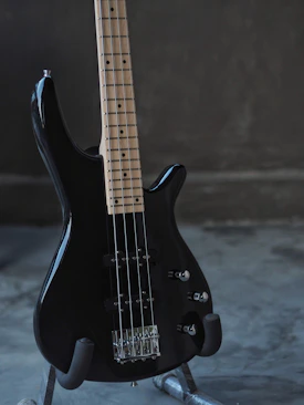 black electric guitar on black and white textile