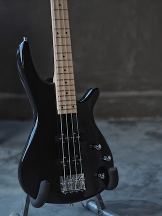 black electric guitar on black and white textile