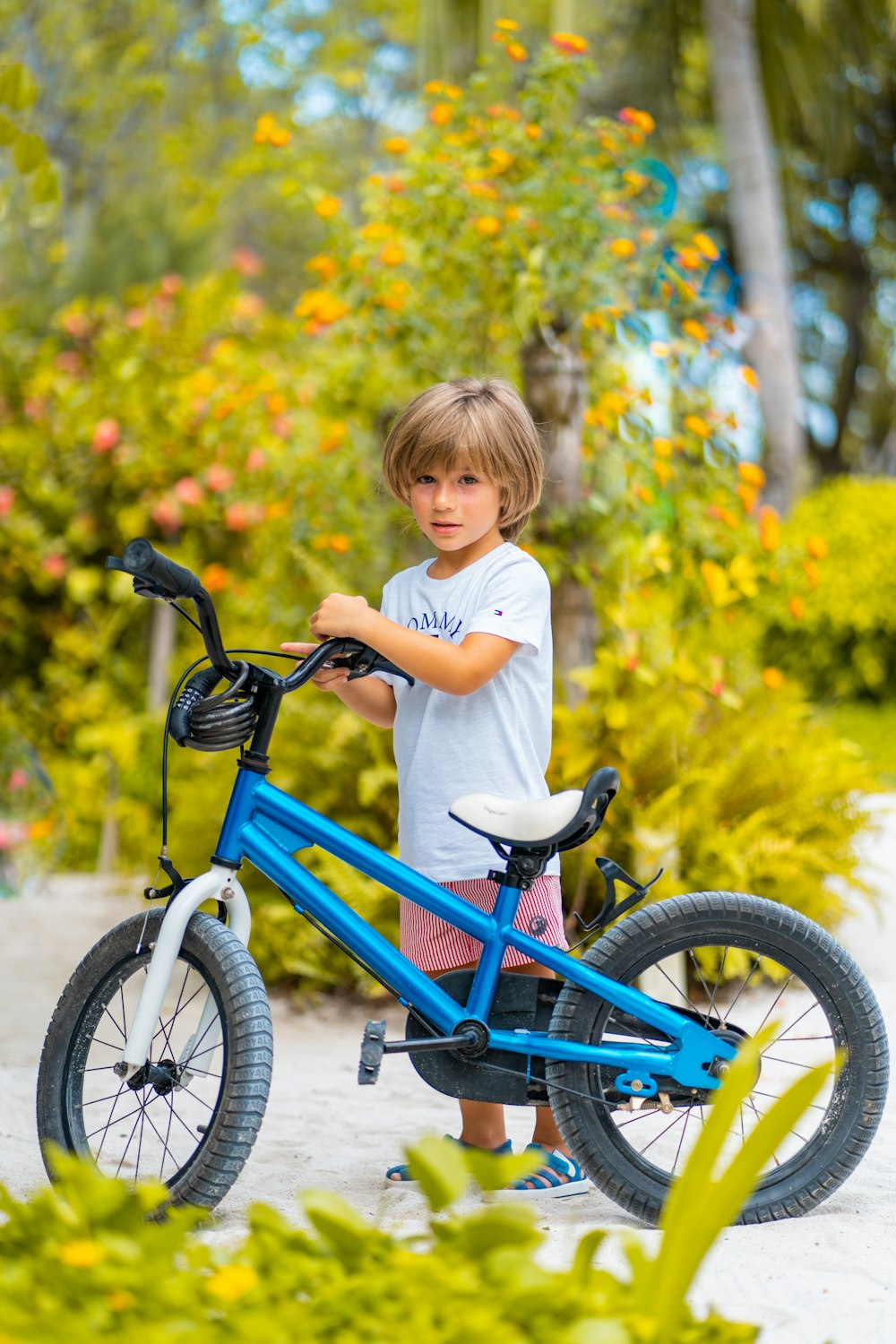 girl in white long sleeve shirt riding blue bicycle during daytime