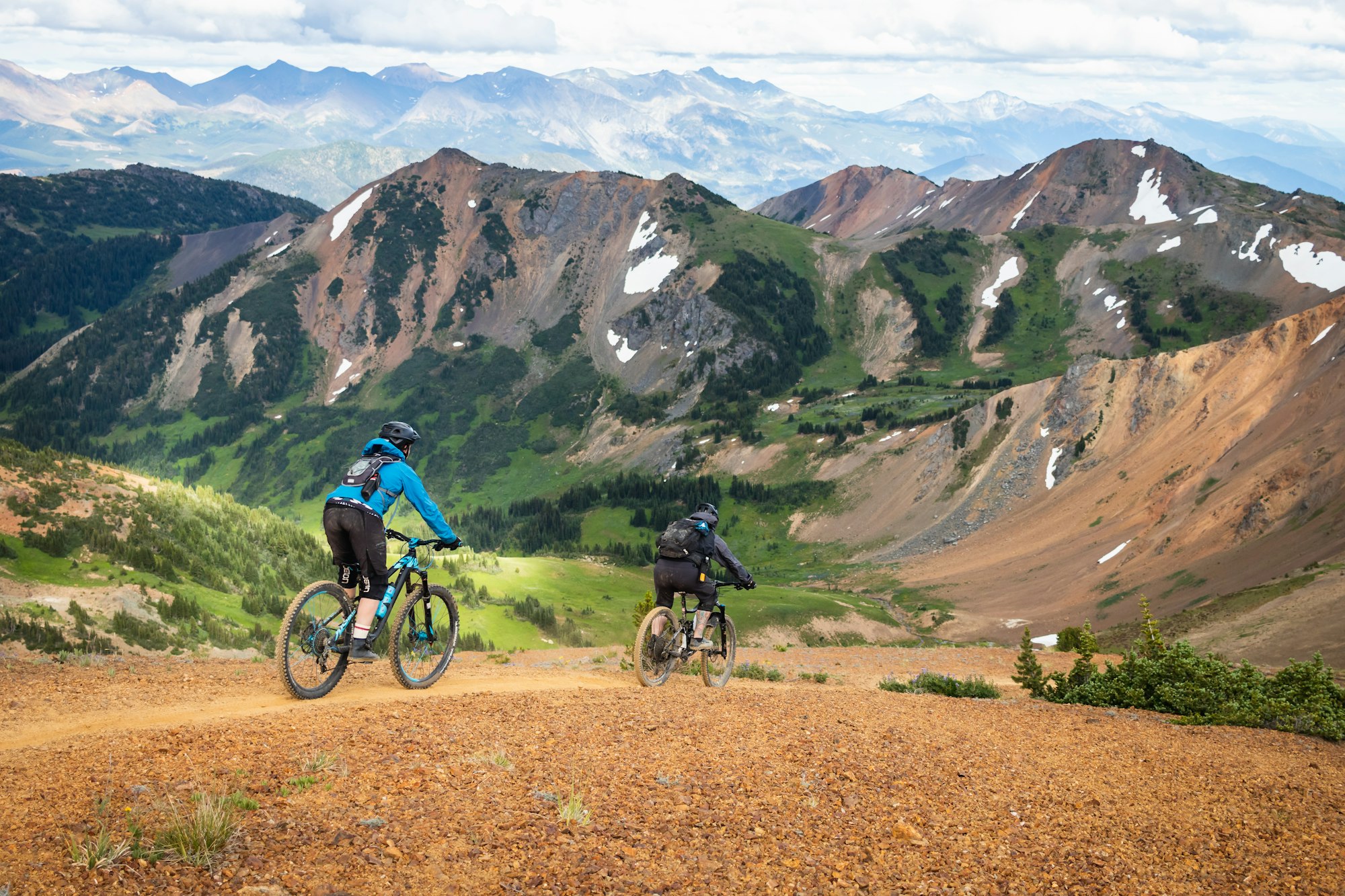 mountain bikers riding on a trail in the mountains