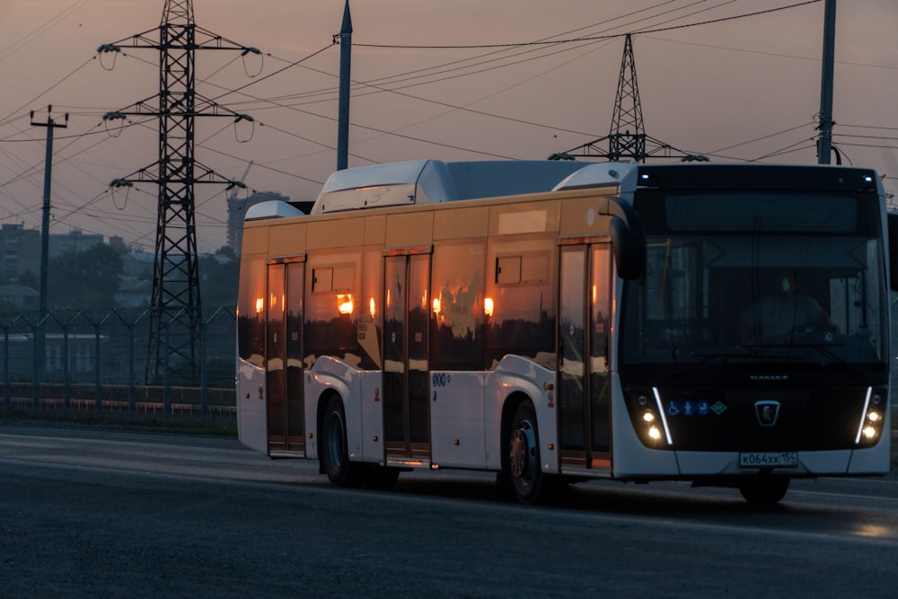 white and red bus on road during daytime