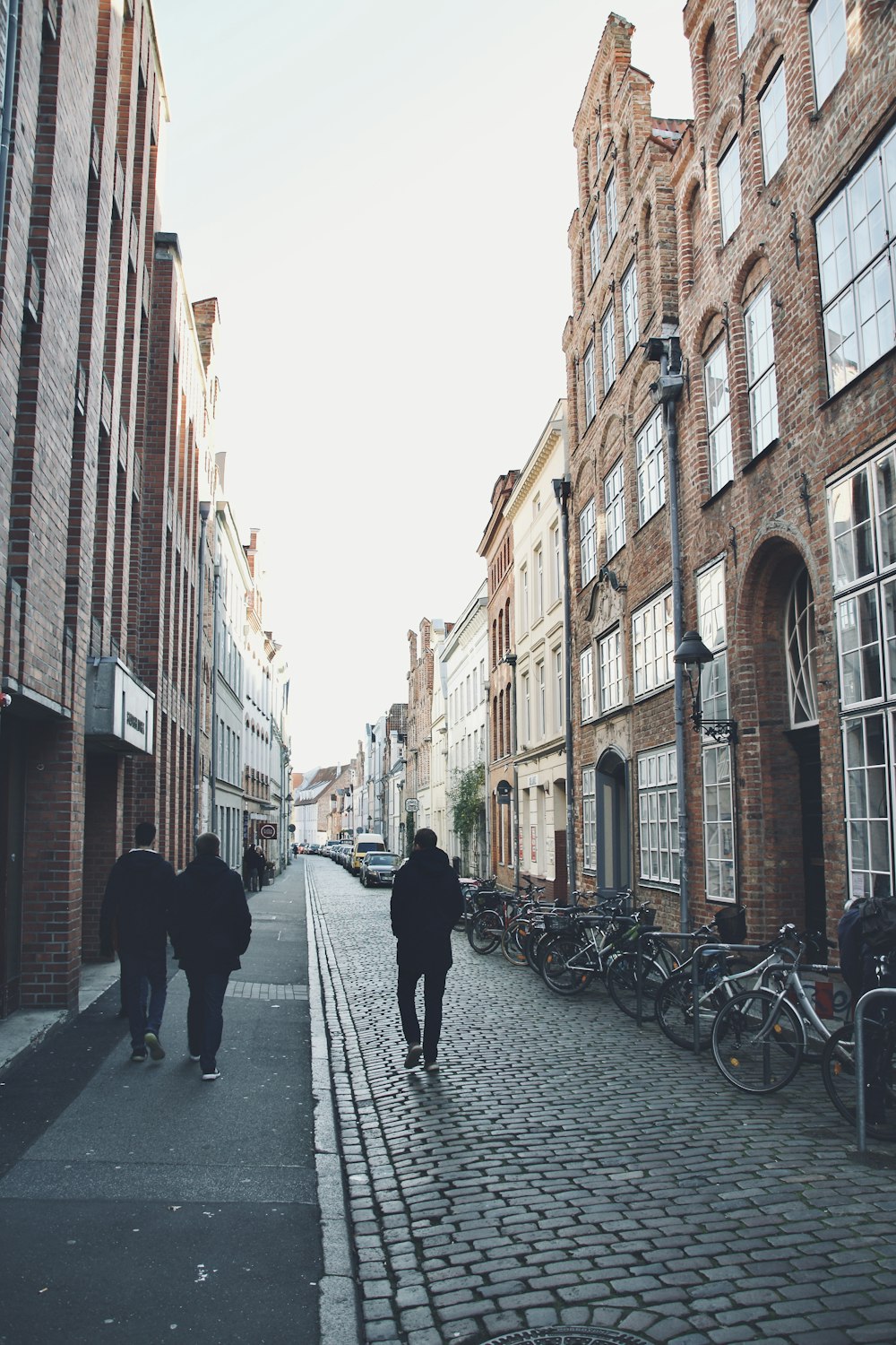 people walking on street between buildings during daytime