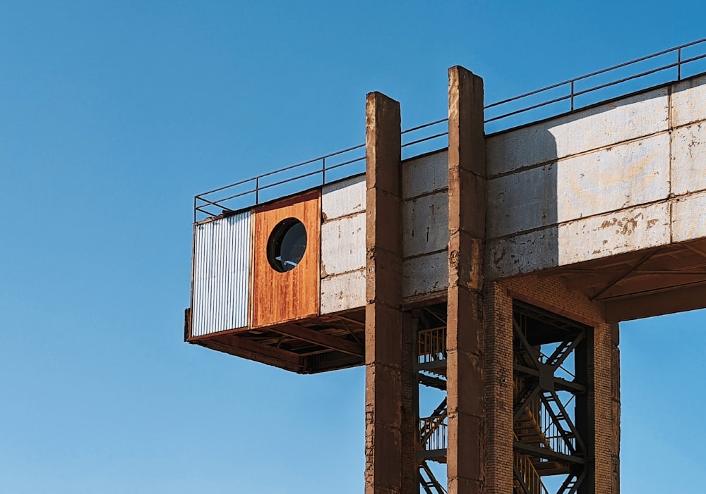 brown wooden birdhouse on brown metal tower