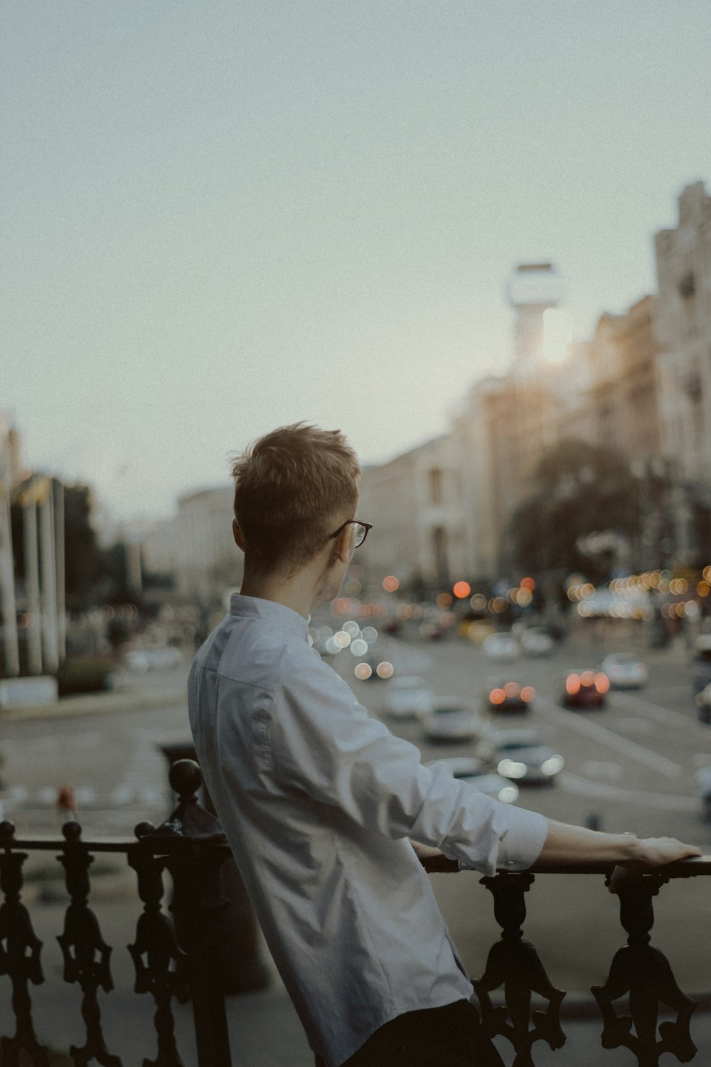 man in white dress shirt sitting on bench during daytime