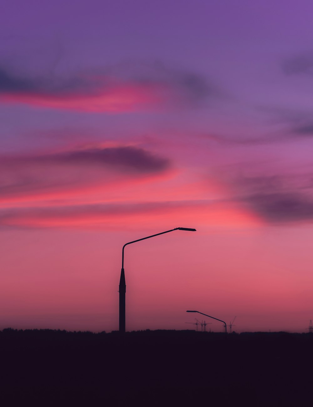 black electric post under purple sky