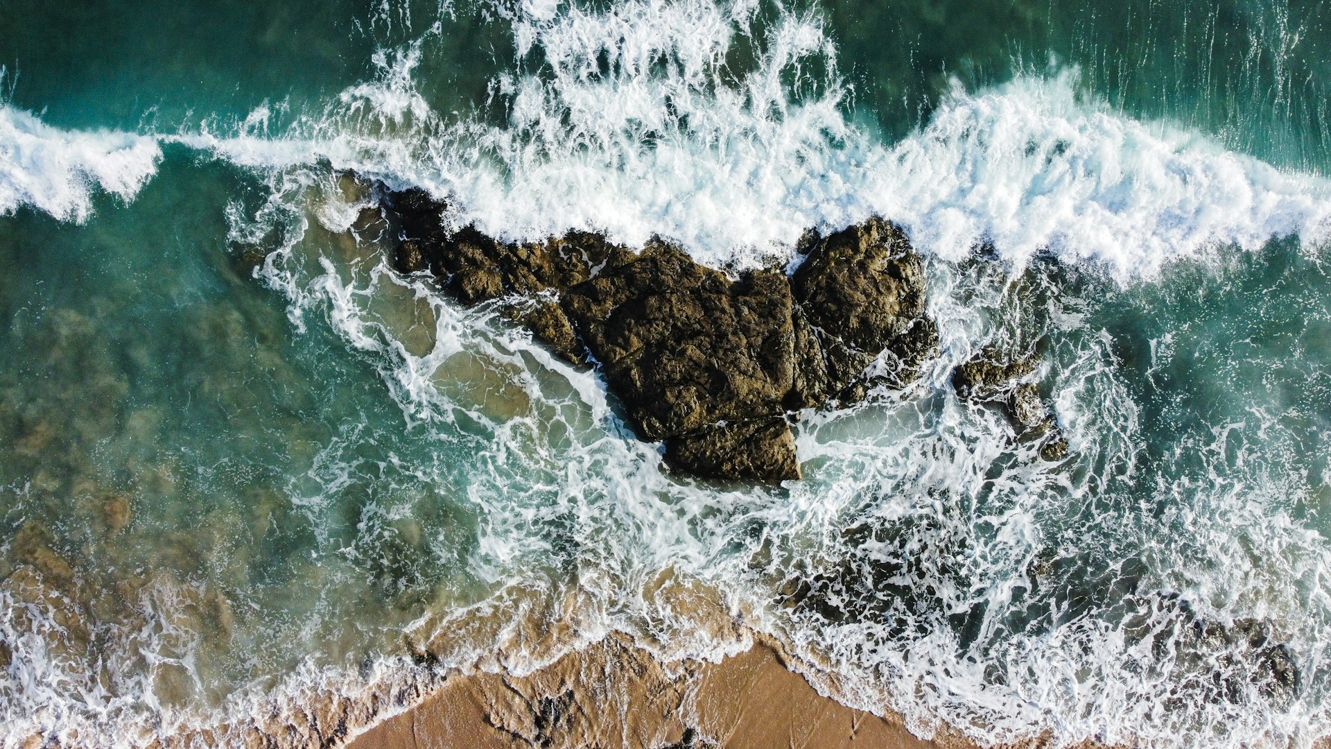 brown rock formation on sea during daytime