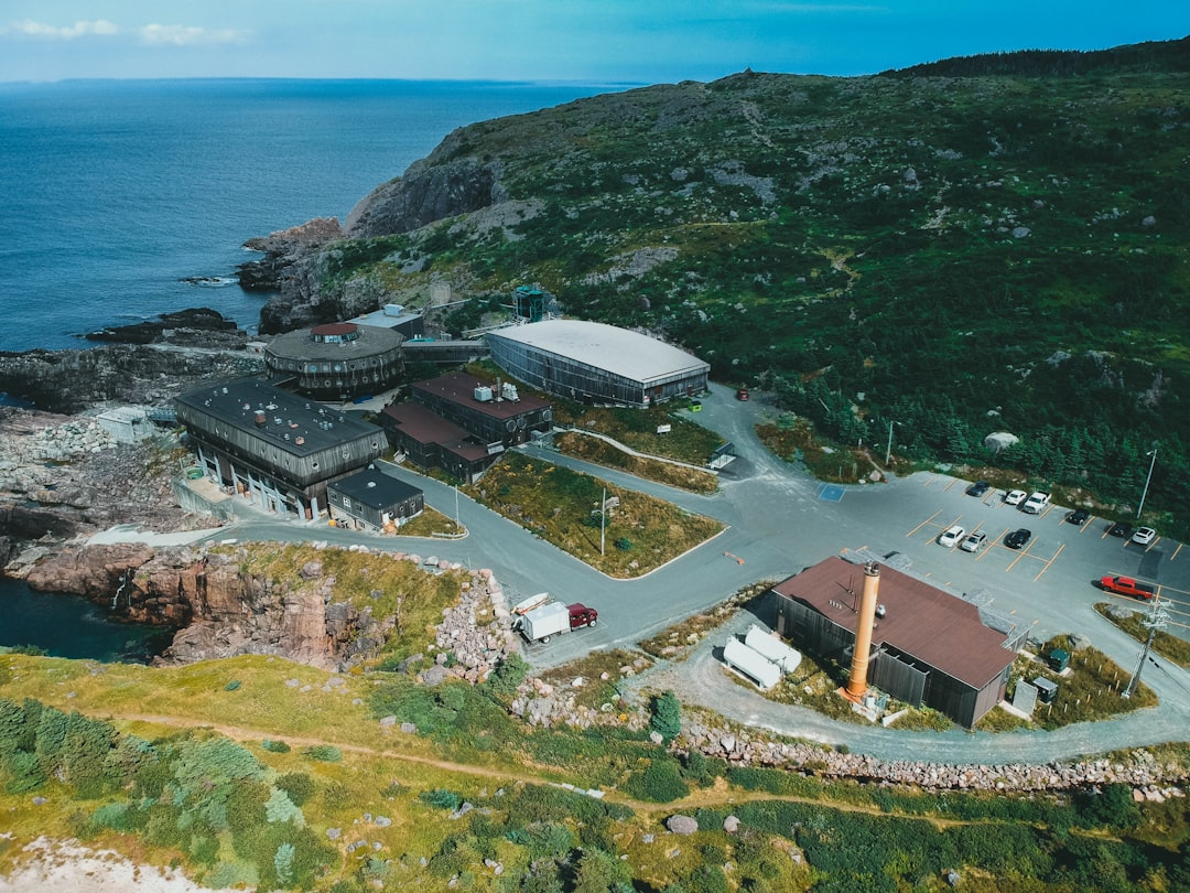 aerial view of green mountain beside body of water during daytime