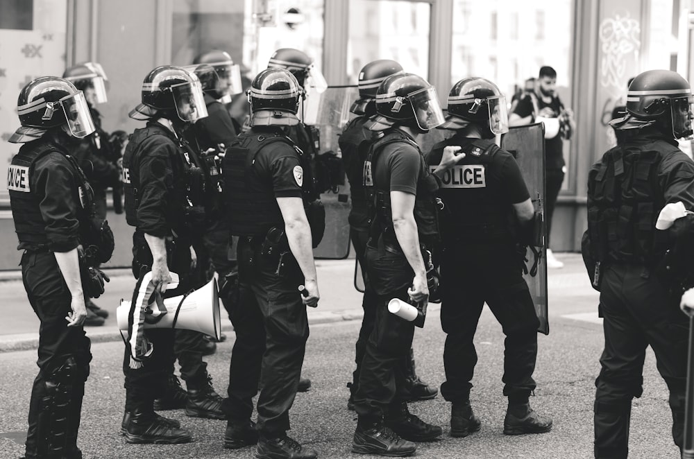 grayscale photo of men in police uniform