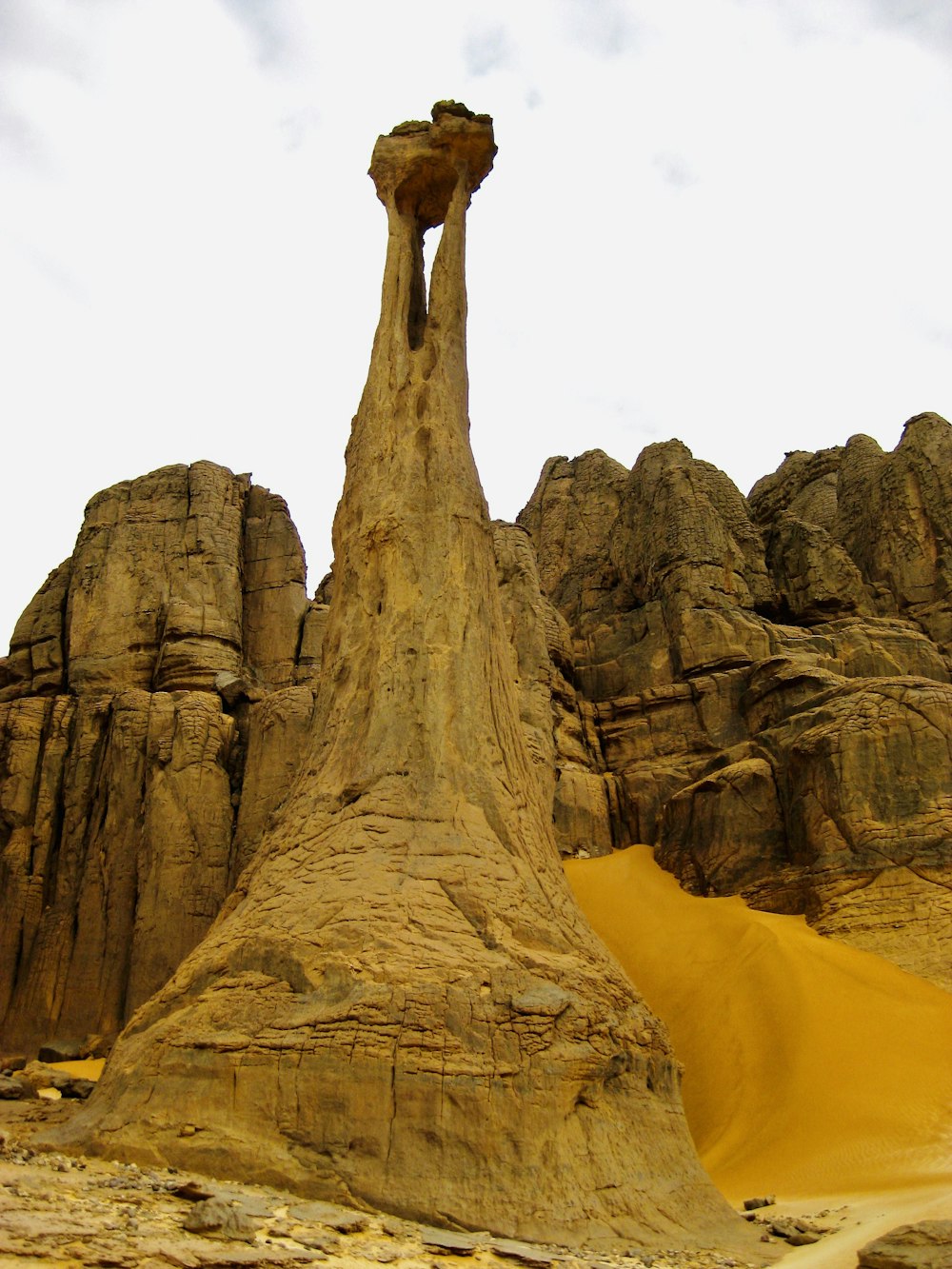 brown rock formation under white sky during daytime