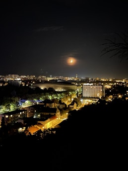 Nighttime cityscape illuminated by solar-powered lights glowing softly.