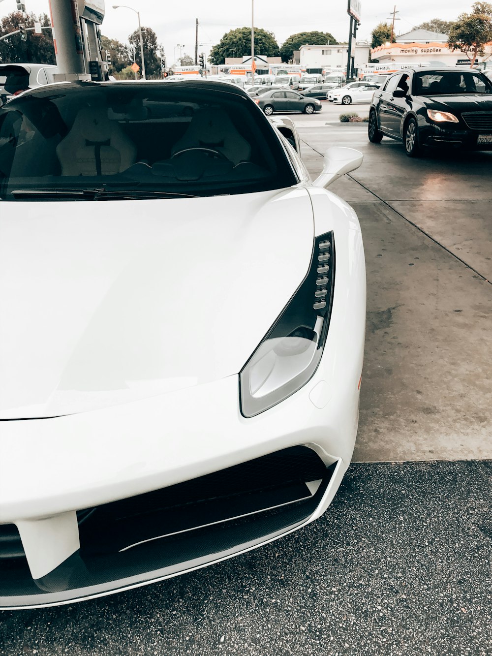 white porsche 911 parked on parking lot during daytime