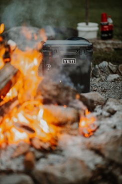 black plastic trash bin on fire