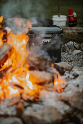 black plastic trash bin on fire