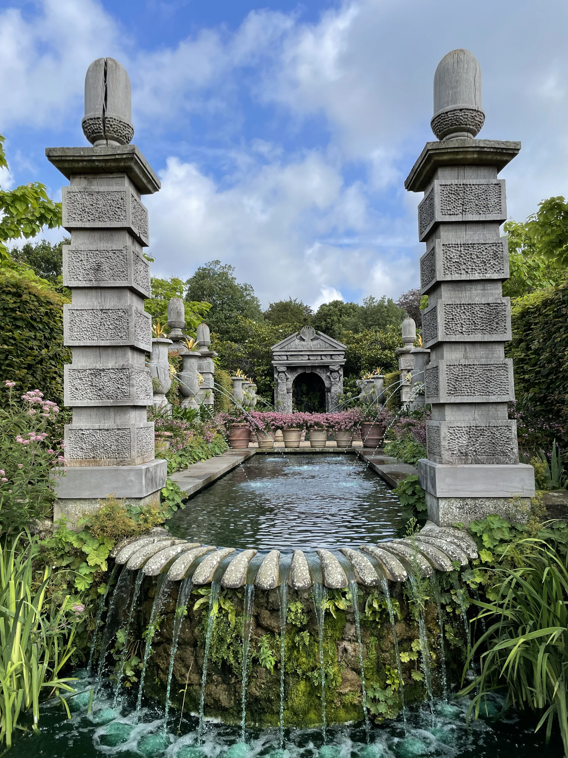 Walled rose garden with a fountain, ready for an intimate ceremony